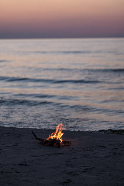 istock small fire burning on the sea shore at night 1041082406