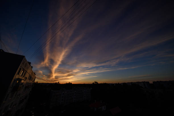 dramatic sunset over the city of Riga, Latvia, rooftops and dark red clouds on black sky