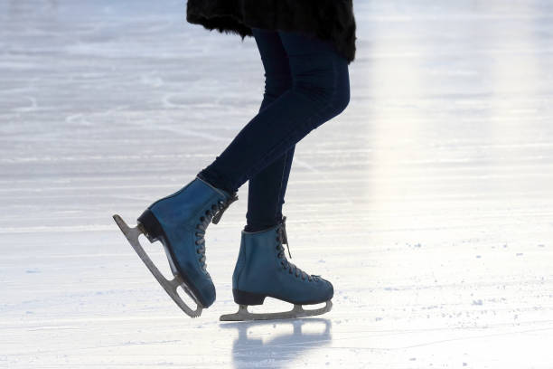 istock foot skating people on the ice rink 1041083420