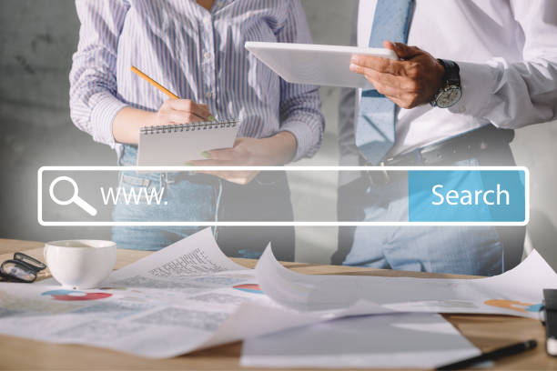 istock cropped view of seo managers working with documents and digital tablet, with website search bar 1041084180