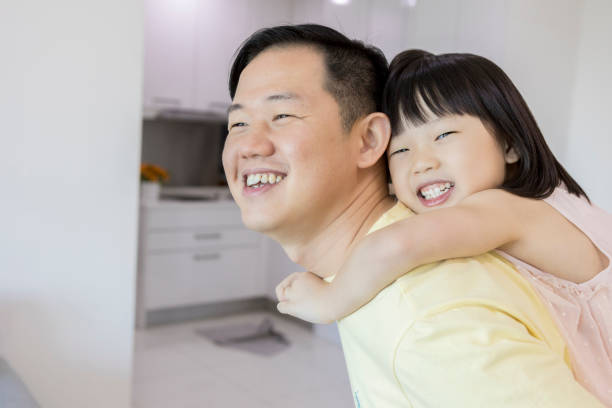istock Little girl rides piggyback on her dad's back 1041087560