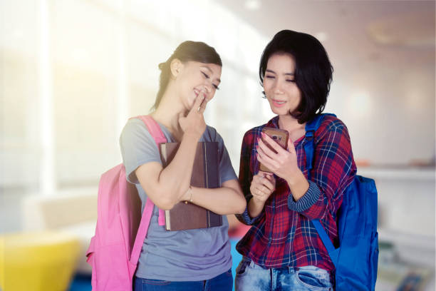 istock Two female college students using a smartphone 1041088840