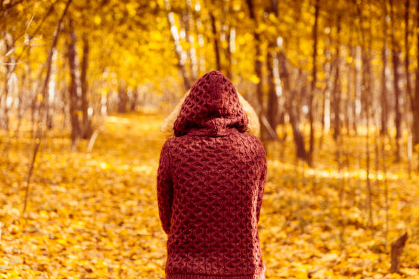istock Woman walking in autumn park 1041089474