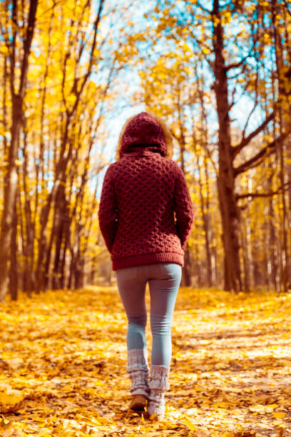 istock Woman walking in autumn park 1041089504