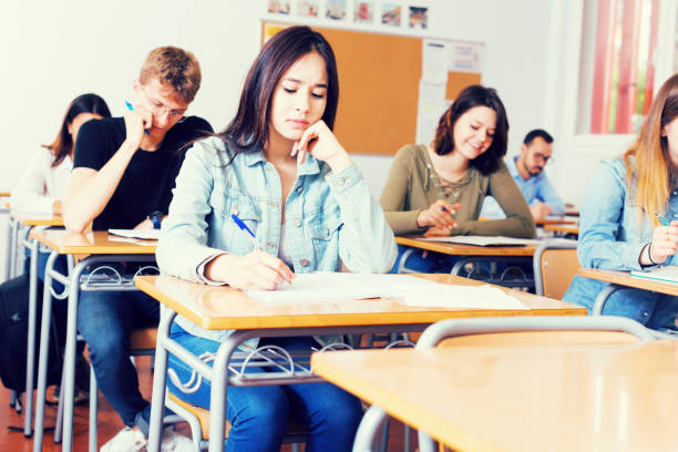 istock Girl writing test in classroom 1041090998