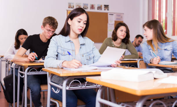 istock Girl writing test in classroom 1041091020