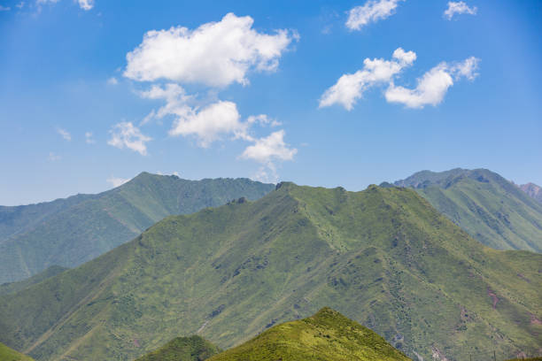 istock Northwest China, qinghai, blue sky, white clouds, mountains with green vegetation 1041091182