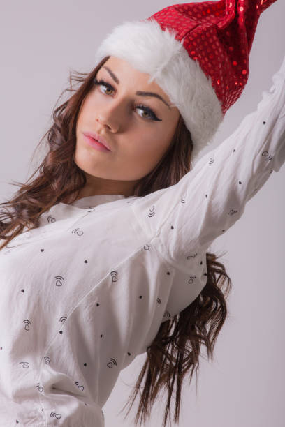 istock Young woman in Santa Claus hat posing 1041091934