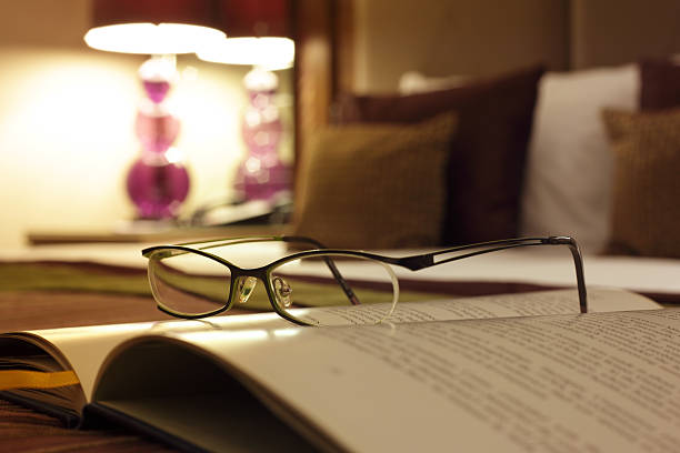 Big book on the table through a stack of books with a place for text, writer day, poet, library.