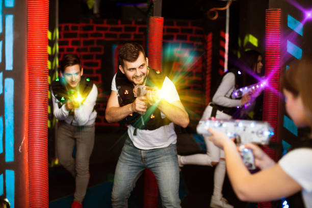istock Guy in colored beams during laser tag game 1041096614