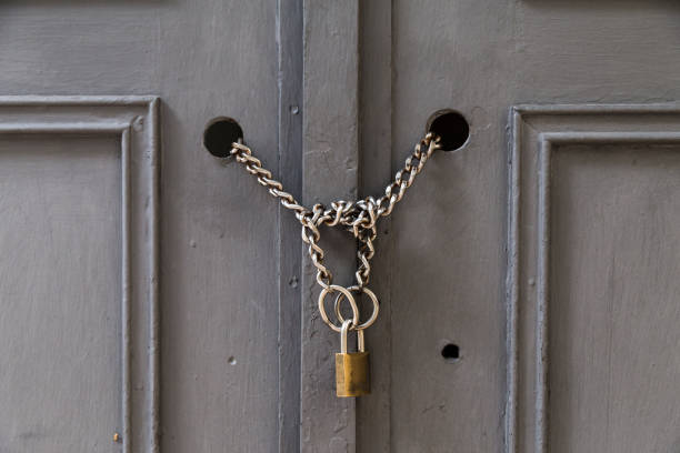 istock A padlock holding chains in a door/gate 1041100522