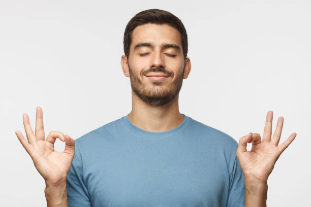 istock Happy smiling man standing with closed eyes, having relaxation while meditating, trying to find balance and harmony isolated. Yoga and meditation. 1041100782