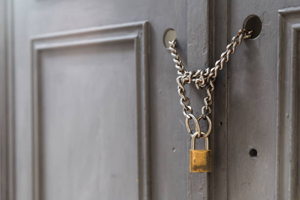 istock A padlock holding chains in a door/gate 1041101064