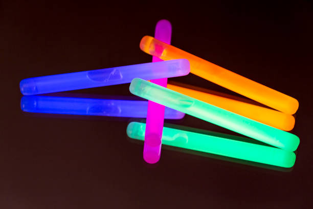 istock Colorful fluorescent light neon big glow stick on mirror reflection black background 1041103482