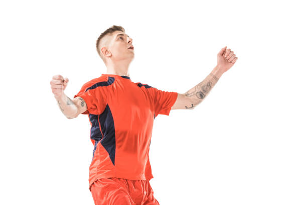 istock triumphing young soccer player looking up isolated on white 1041103682