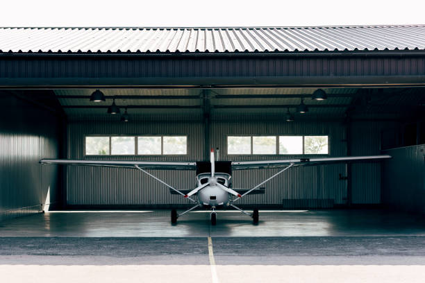istock small modern white airplane standing in hangar 1041103786