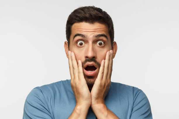 istock Young man isolated on grey background, dressed in casual clothes, with round eyes, experiencing deep astonishment and fear 1041104278