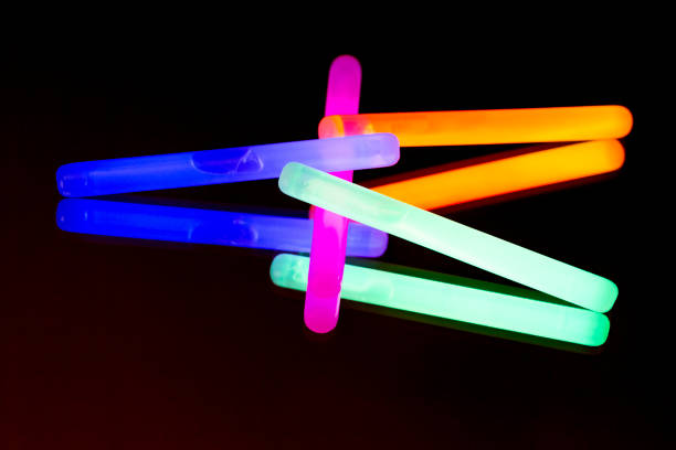 istock Colorful fluorescent light neon big glow stick on mirror reflection black background 1041105250