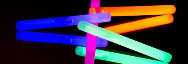 istock Colorful fluorescent light neon big glow stick on mirror reflection black background 1041106034