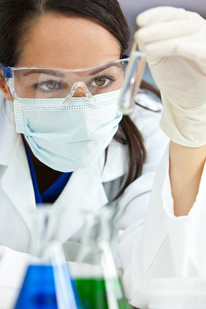 istock Female Scientific Researcher With Clear Solution In Laboratory 104110627