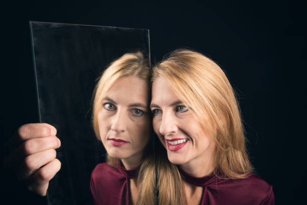 istock Woman Holding Mirror Reflecting True Feelings 1041111488