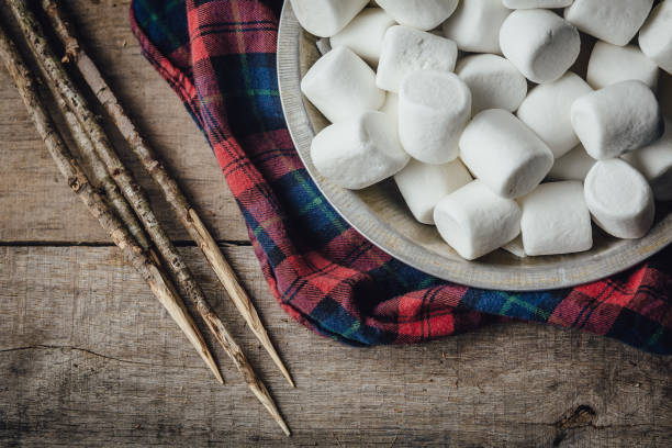 Bowl of marshmallows and skewers with lumberjack shirt stock photo