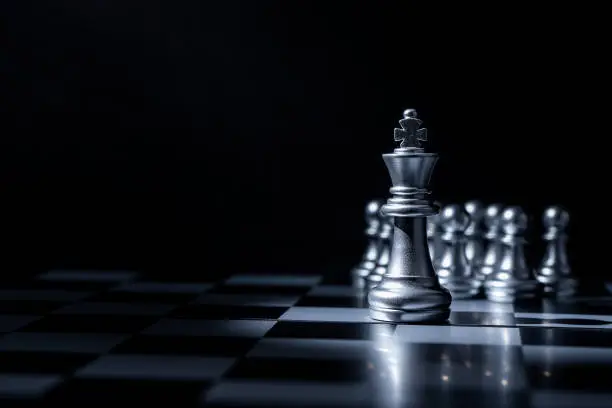 Photo of Chess board game for business concept in light and shadow.