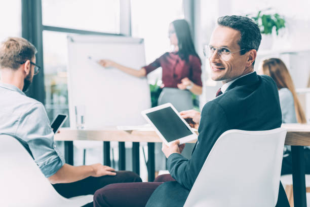 istock handsome businessman with digital tablet at conference 1041114590