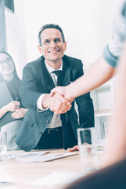 istock business partners shaking hands in modern office 1041114614