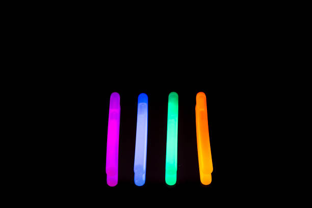 istock Colorful fluorescent light neon big glow stick on mirror reflection black background 1041116528