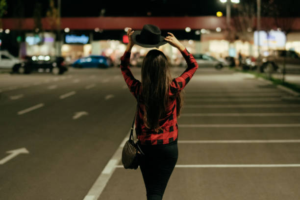 istock Smiling woman looking over shoulder in city 1041116596