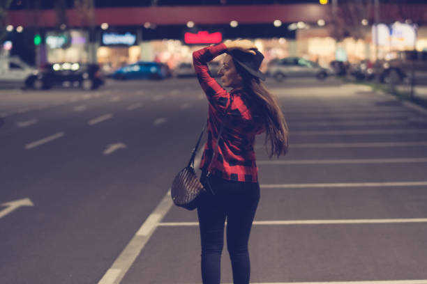 istock Smiling woman looking over shoulder in city 1041117062