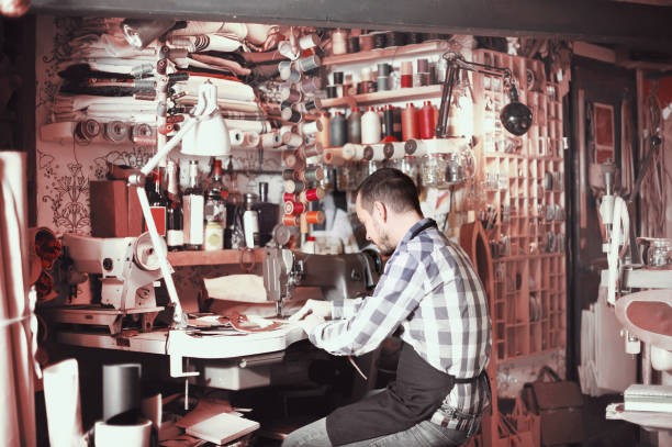 istock Smiling male worker working on stitches for belt 1041117294