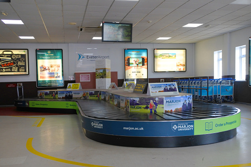 Exeter, Devon, UK - 06 August, 2018:The baggage collection area at Exeter Airport, Devon, UK. Exeter is a busy regional airport with destinations throughout Europe and North America.