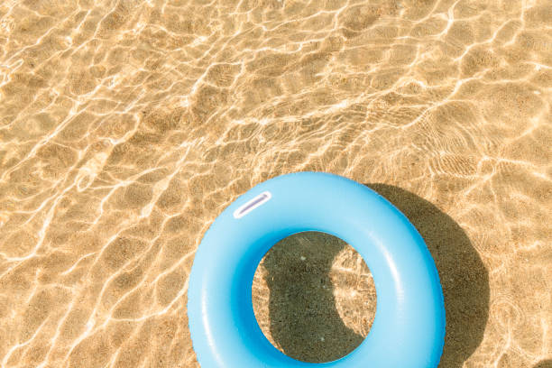 istock Blue rubber ring floating on the clear shallow sea at Pedn Vounder Beach, Cornwall 1041122728