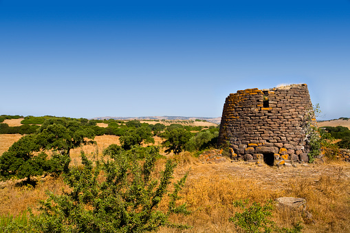 Nuraghe Ruggiu, at Chiaramonti, near Sassari (Italy). Nuraghes are the main type of megalithic edifice found in Sardinia, dating back before 1000 BC, now the symbol this region and its distinctive culture.
