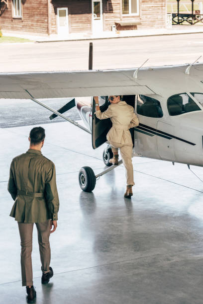 istock high angle view of stylish man walking while his girlfriend boarding in plane 1041125710