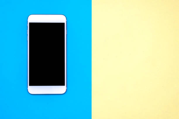 istock Flat lay design with blank on a smart phone for text messages. Minimalist yellow and blue background. Minimalist concept 1041126342