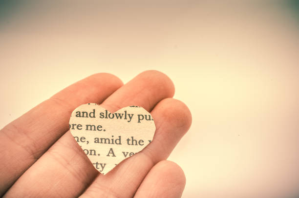 istock Heart shaped burnt out of texted  paper 1041127432