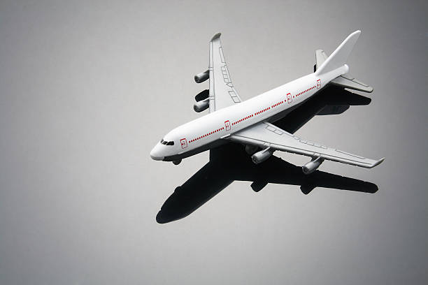istock White toy commercial airline with red windows 104113742