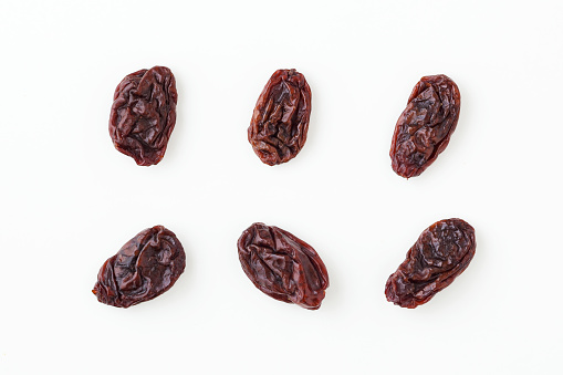 Raisins isolated on white background, top view