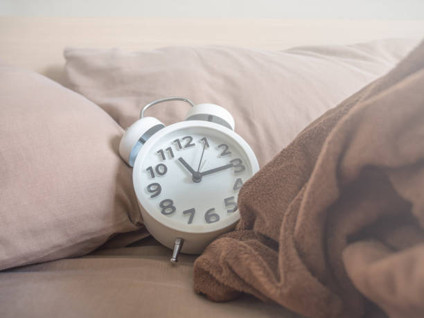 istock White alarm clock in the bedroom. 1041144084