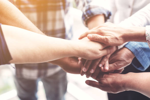 people hand assemble as a connection meeting teamwork concept. group of people colleague assembly hands as a business or work achievement. man and women touch each other hands. teamwork conceptual. - community teamwork human hand organization imagens e fotografias de stock