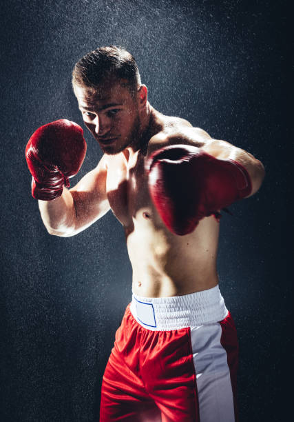 istock Boxing man ready to fight in the rain. 1041144094
