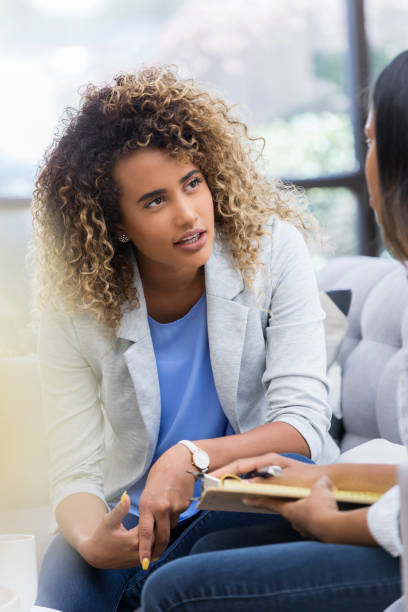 istock Young woman talks with counselor 1041145184