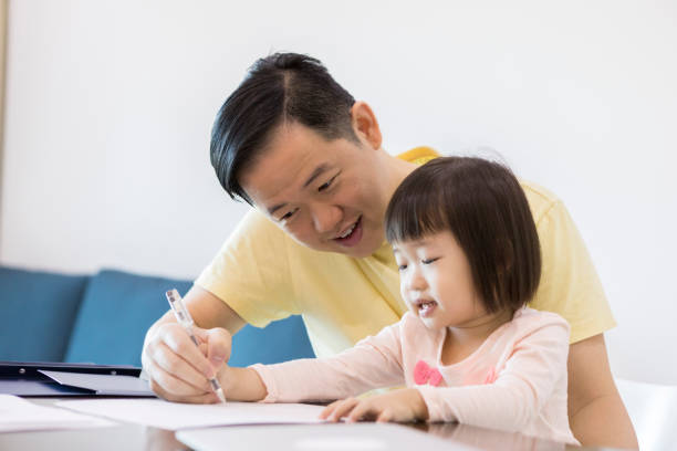 istock Caring dad colors with little girl 1041145410