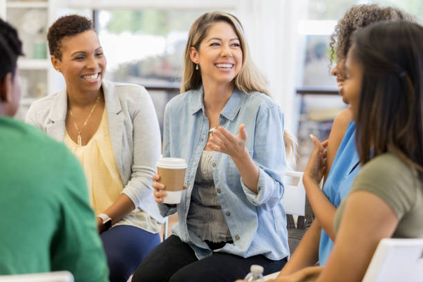 istock Mid adult woman talks during support group meeting 1041146644