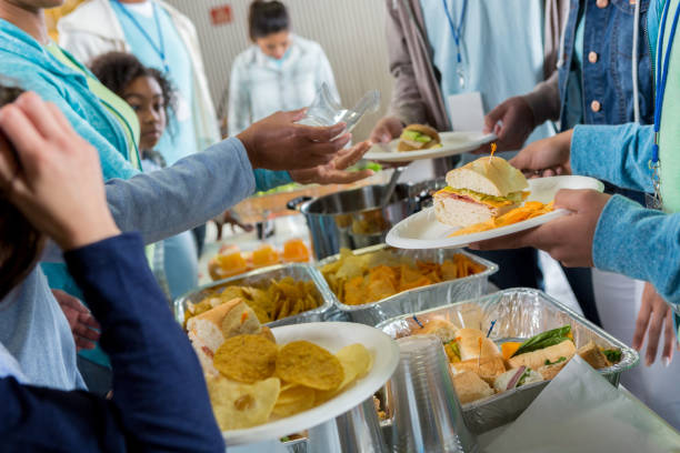 istock Unrecognizable volunteers serving at soup kitchen 1041147252