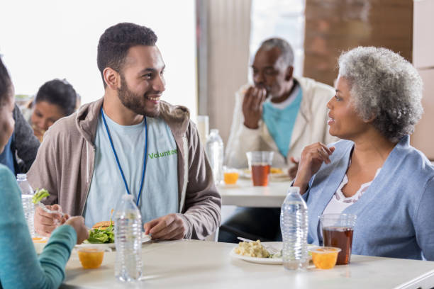istock Confident young man enjoys soup kitchen meal 1041147290