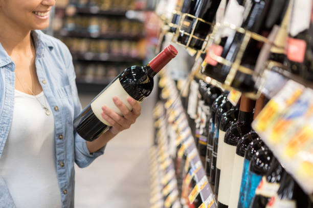 istock Unrecognizable woman chooses dinner wine at store 1041147580